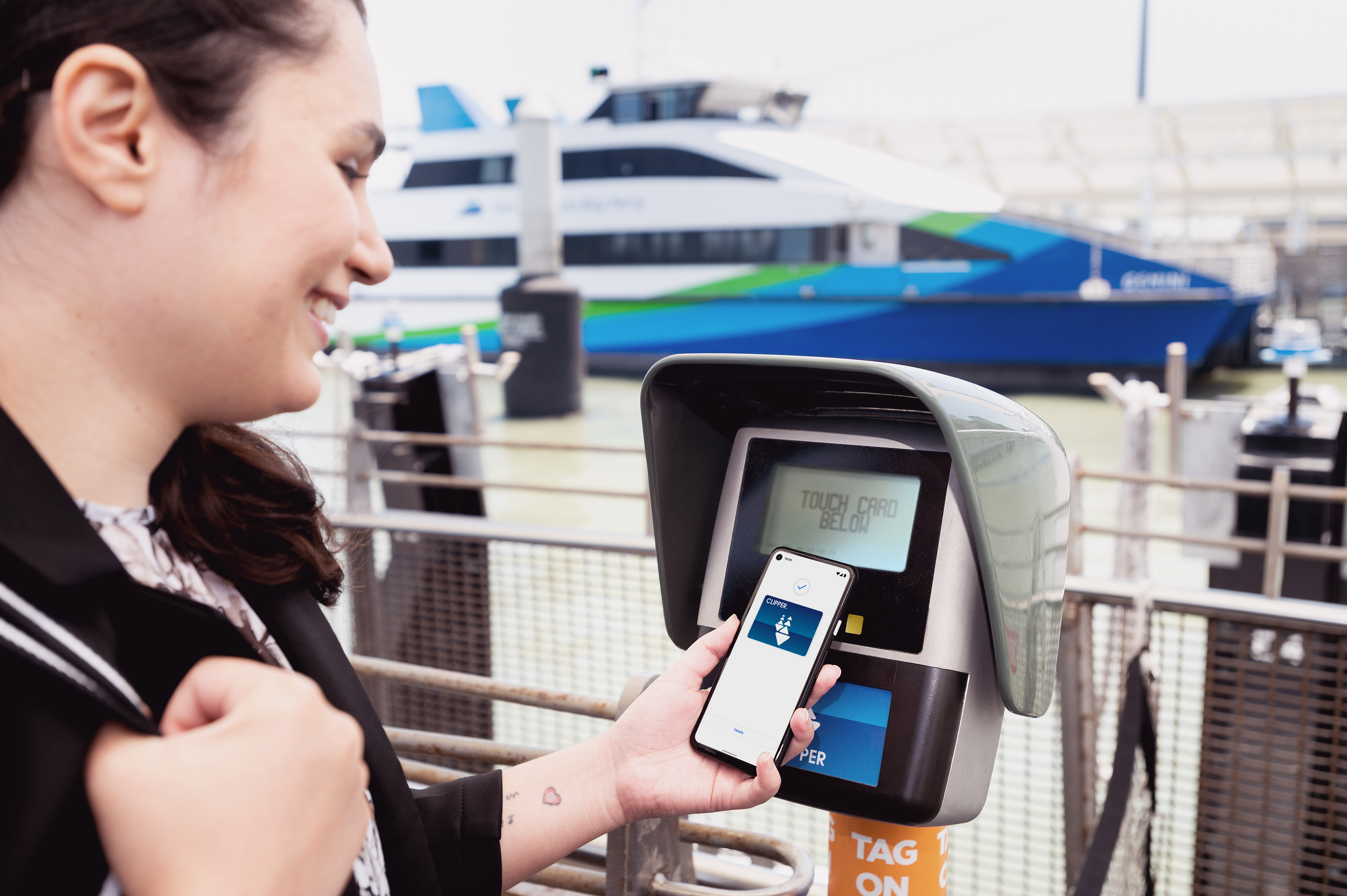 A woman uses Clipper on her smartphone to pay for the San Francisco Bay Ferry