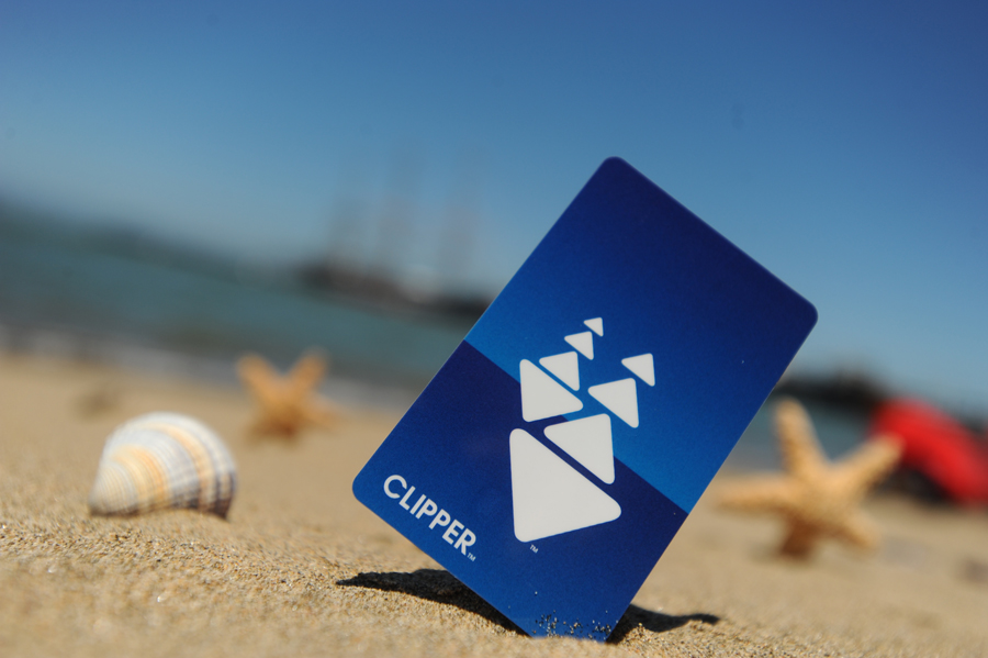 Close-up of a plastic Clipper card at the beach propped up in the sand